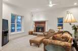Cozy family room features a brick fireplace, creating a warm and inviting atmosphere.