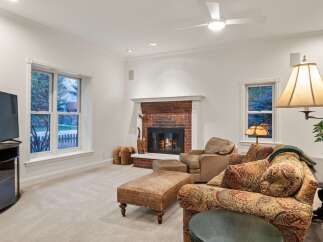 Cozy family room features a brick fireplace, creating a warm and inviting atmosphere.