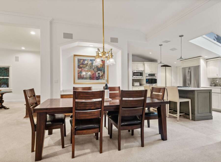 This stunning dining room boasts a spacious layout, perfect for hosting gatherings.