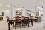 This stunning dining room boasts a spacious layout, perfect for hosting gatherings.