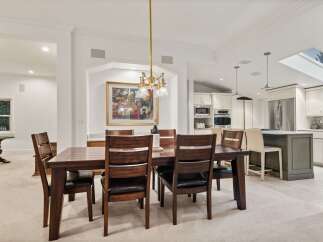 This stunning dining room boasts a spacious layout, perfect for hosting gatherings.