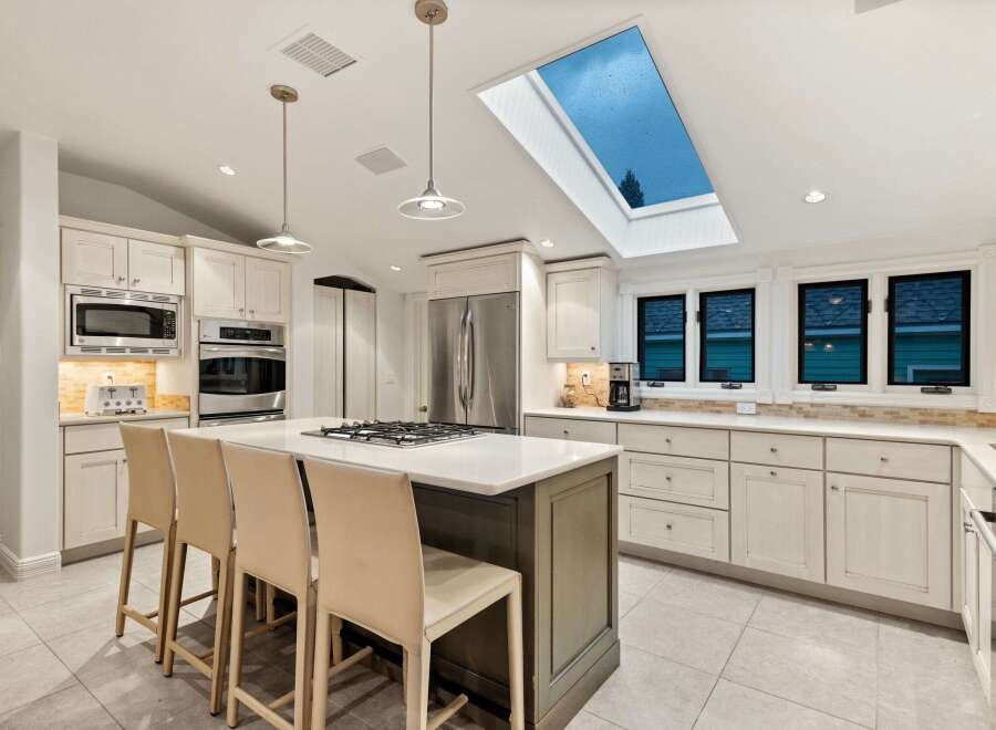 This stunning kitchen boasts a spacious island with seating, perfect for casual dining and entertaining.
