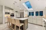 This stunning kitchen boasts a spacious island with seating, perfect for casual dining and entertaining.