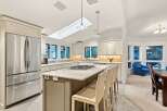 This stunning kitchen boasts a spacious island with seating, perfect for casual dining and entertaining.