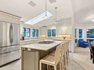 This stunning kitchen boasts a spacious island with seating, perfect for casual dining and entertaining.
