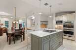 This stunning kitchen boasts a large island with a gas cooktop, perfect for entertaining.