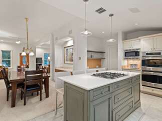 This stunning kitchen boasts a large island with a gas cooktop, perfect for entertaining.