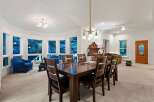 This stunning home boasts a spacious dining area with a large wooden table, perfect for family gatherings.