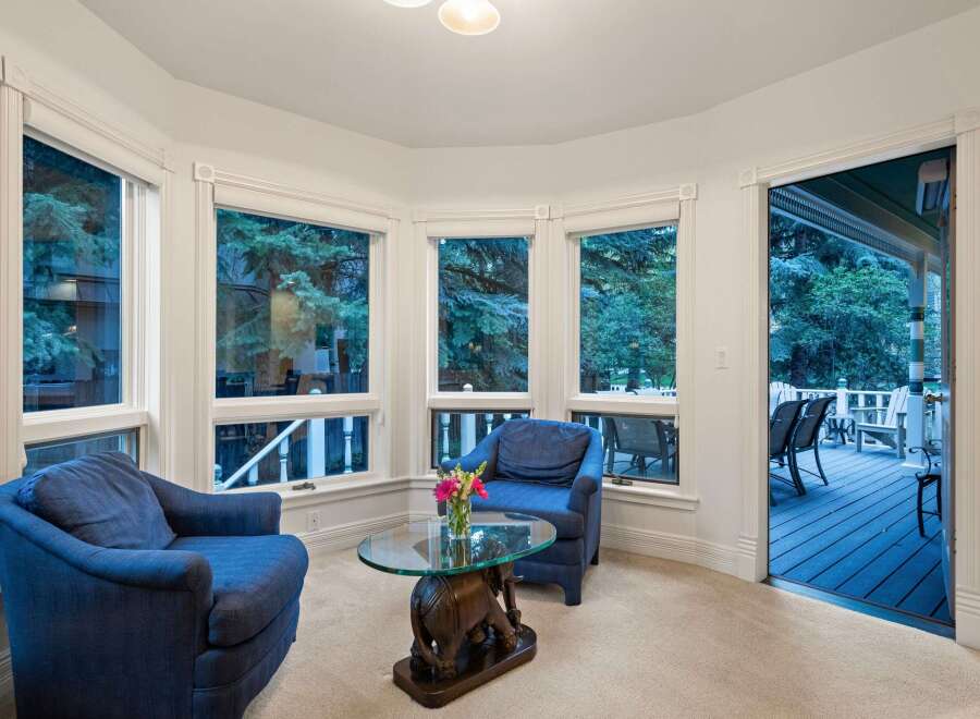 Cozy sunroom with ample natural light and stunning views.