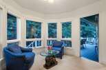 Cozy sunroom with ample natural light and stunning views.
