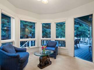Cozy sunroom with ample natural light and stunning views.