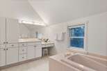This luxurious bathroom boasts a spacious bathtub, perfect for relaxation.