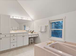 This luxurious bathroom boasts a spacious bathtub, perfect for relaxation.