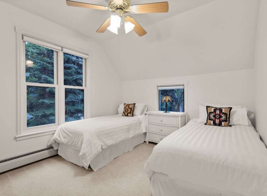 Charming bedroom with twin beds, offering a serene escape.