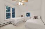 Charming bedroom with twin beds, offering a serene escape.