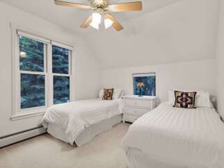 Charming bedroom with twin beds, offering a serene escape.