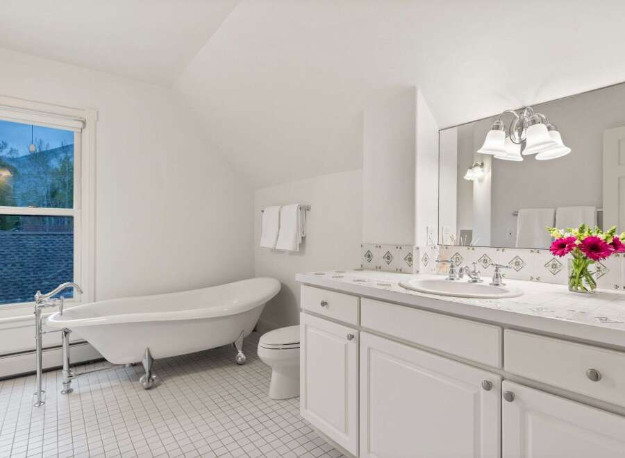 This charming bathroom boasts a clawfoot tub, perfect for relaxing soaks.