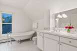 This charming bathroom boasts a clawfoot tub, perfect for relaxing soaks.