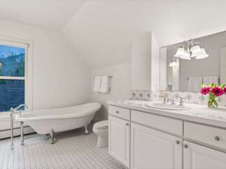 This charming bathroom boasts a clawfoot tub, perfect for relaxing soaks.