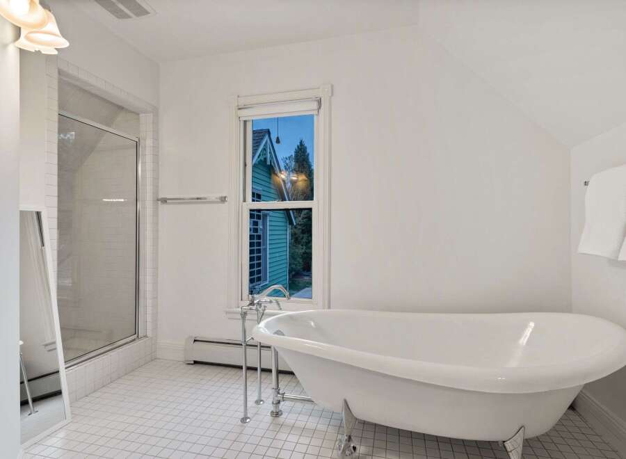 This stunning bathroom boasts a classic clawfoot tub, perfect for relaxing soaks.