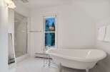 This stunning bathroom boasts a classic clawfoot tub, perfect for relaxing soaks.