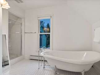 This stunning bathroom boasts a classic clawfoot tub, perfect for relaxing soaks.