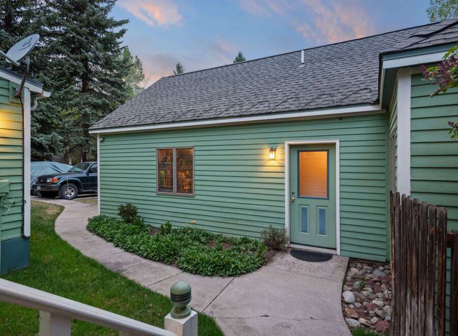 Charming green guest house with private entrance and walkway.