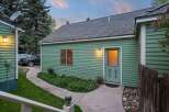 Charming green guest house with private entrance and walkway.