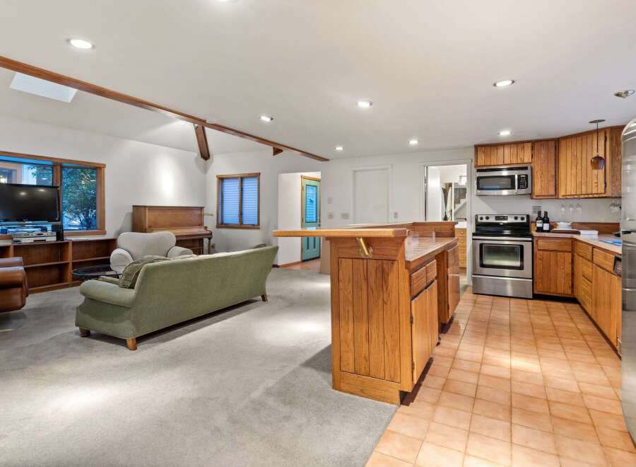 This stunning property boasts an open-concept living area with hardwood floors and a cozy fireplace, perfect for entertaining guests.