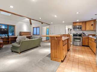 This stunning property boasts an open-concept living area with hardwood floors and a cozy fireplace, perfect for entertaining guests.