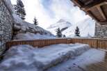 This stunning property boasts a private balcony with breathtaking mountain views, perfect for enjoying the crisp winter air.