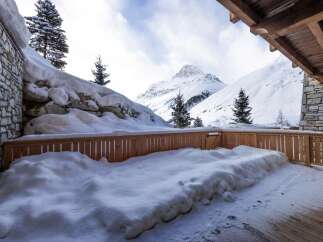 This stunning property boasts a private balcony with breathtaking mountain views, perfect for enjoying the crisp winter air.