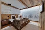 Luxury chalet bedroom with stunning mountain views.