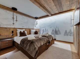 Luxury chalet bedroom with stunning mountain views.