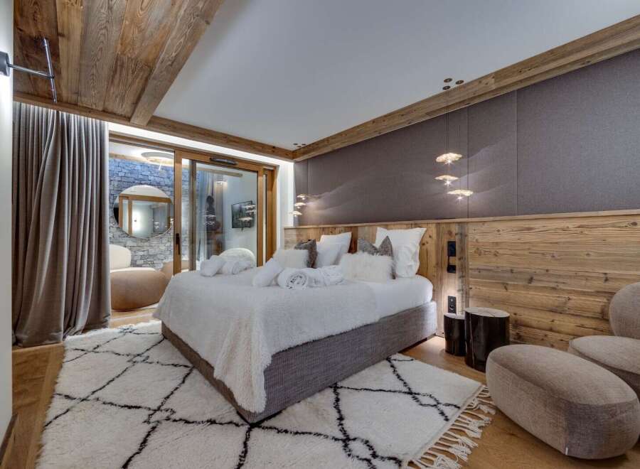 Luxurious chalet bedroom with stunning wood features and cozy textiles.