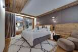Luxurious chalet bedroom with stunning wood features and cozy textiles.