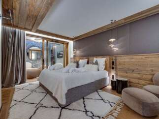 Luxurious chalet bedroom with stunning wood features and cozy textiles.
