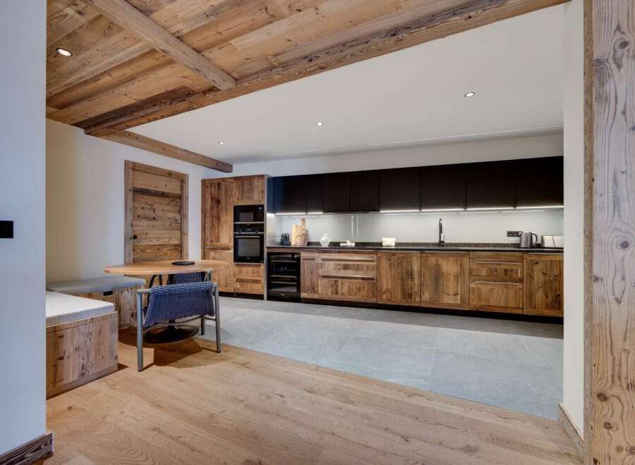 This stunning property boasts a rustic-chic kitchen with reclaimed wood cabinetry and modern appliances.