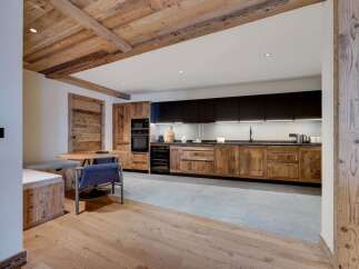 This stunning property boasts a rustic-chic kitchen with reclaimed wood cabinetry and modern appliances.