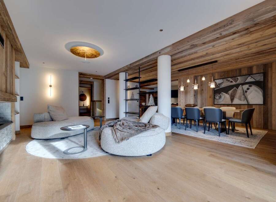 This stunning apartment boasts a spacious open-plan living area with a cozy seating arrangement and a separate dining area perfect for entertaining.