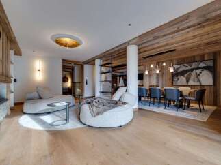 This stunning apartment boasts a spacious open-plan living area with a cozy seating arrangement and a separate dining area perfect for entertaining.