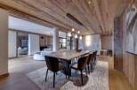 This stunning chalet boasts a spacious open-plan living area with a large dining table perfect for entertaining.