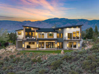 Stunning modern home nestled in the mountains with breathtaking sunset views.