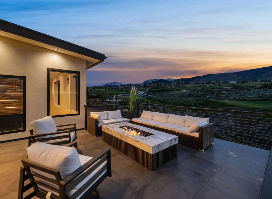 Luxury patio with fire pit and stunning sunset views.