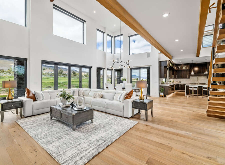 This stunning home boasts an open floor plan with soaring ceilings and expansive windows offering breathtaking views.