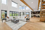 This stunning home boasts an open floor plan with soaring ceilings and expansive windows offering breathtaking views.