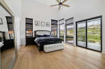 Luxurious bedroom with stunning mountain views and hardwood floors.