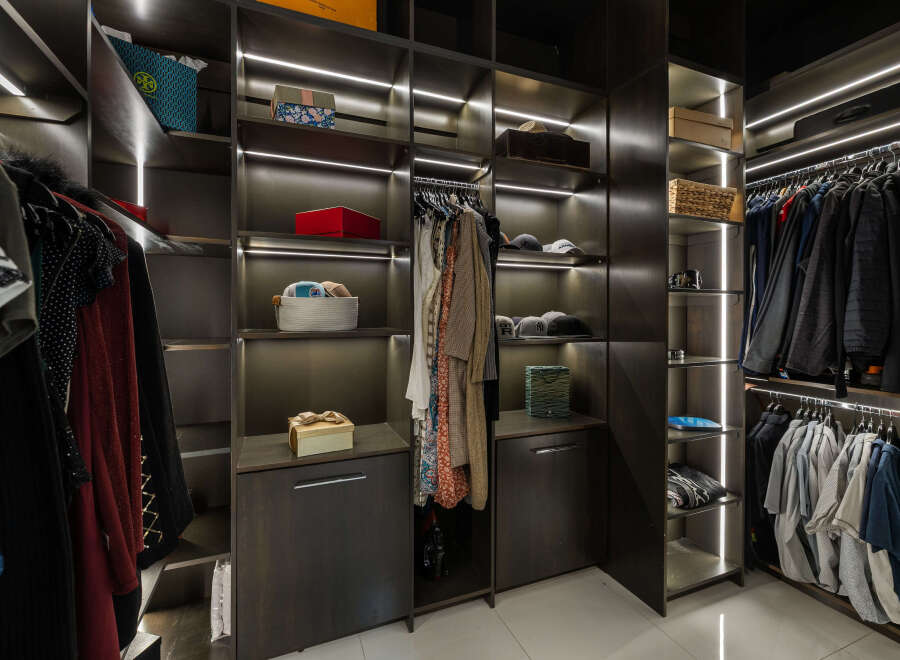This luxurious walk-in closet boasts ample storage space with custom shelving and LED lighting.