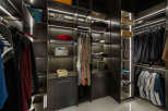 This luxurious walk-in closet boasts ample storage space with custom shelving and LED lighting.