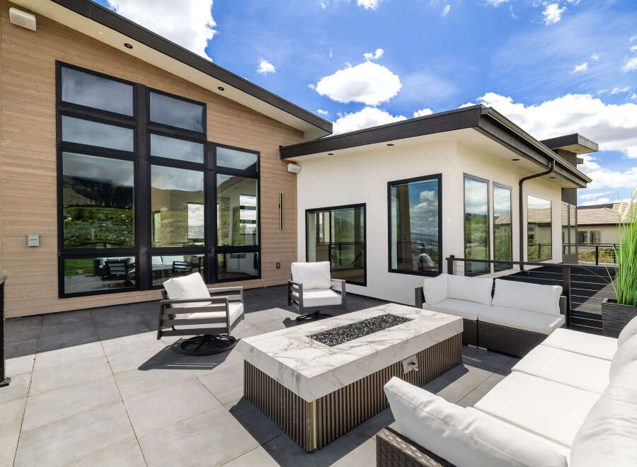 This stunning property boasts a spacious outdoor patio perfect for entertaining, complete with a modern fire pit and comfortable seating.